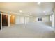 Spacious finished basement with neutral carpet and ample natural light, perfect for recreation or storage at 762 Tailings Dr, Monument, CO 80132