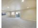 A large, open basement with carpeting, recessed lighting, a sliding glass door, and bright walls at 762 Tailings Dr, Monument, CO 80132