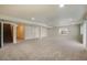 Spacious carpeted basement with stairs and window, perfect for recreation or storage at 762 Tailings Dr, Monument, CO 80132
