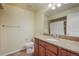 Bathroom featuring granite counters, wood cabinets, vanity mirror and tile floors at 762 Tailings Dr, Monument, CO 80132
