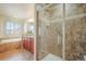 Bright bathroom featuring a shower with glass door, separate tub, and double vanity at 762 Tailings Dr, Monument, CO 80132