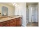 Bathroom with a granite countertop, double sinks and walk in shower at 762 Tailings Dr, Monument, CO 80132