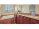 Bright bathroom featuring a soaking tub, double vanity with granite countertops, and ample storage at 762 Tailings Dr, Monument, CO 80132