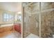 Bathroom with a glass shower, soaking tub and wood look floors at 762 Tailings Dr, Monument, CO 80132
