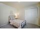 Cozy bedroom with a floral-patterned bedspread, white walls, carpet floors, and double door closet at 762 Tailings Dr, Monument, CO 80132