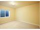 Empty bedroom with neutral walls, carpet, and a window, offering a blank canvas for personal design at 762 Tailings Dr, Monument, CO 80132