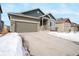 Home with a spacious driveway and a two-car garage showcasing its inviting curb appeal and modern design at 762 Tailings Dr, Monument, CO 80132