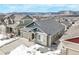 Elevated angle shows a home in a snowy neighborhood with mountain views at 762 Tailings Dr, Monument, CO 80132