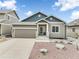 Charming single-Gathering home with a well-manicured lawn, concrete driveway, and attached two-car garage at 762 Tailings Dr, Monument, CO 80132
