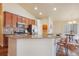 Open kitchen features stainless appliances, an island with seating, and wood floors at 762 Tailings Dr, Monument, CO 80132
