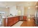 Kitchen with a breakfast bar overlooking the living room, stainless steel appliances and wood floors at 762 Tailings Dr, Monument, CO 80132