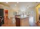 Bright, open kitchen with wood floors, an island, stainless steel appliances, and access to the deck and living area at 762 Tailings Dr, Monument, CO 80132