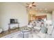 Open-concept living room featuring hardwood floors, ceiling fan, and seamless flow to the kitchen at 762 Tailings Dr, Monument, CO 80132