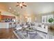Open concept living room with hardwood floors, bar seating, and a seamless flow to the kitchen and dining area at 762 Tailings Dr, Monument, CO 80132