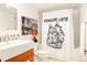 Bathroom featuring a modern vanity, decorative mirror, and shower with a stylish 'Icehouse Lofts' themed curtain at 1801 Wynkoop St # 411, Denver, CO 80202