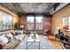 Bright living room with exposed brick, large windows, and stylish decor at 1801 Wynkoop St # 411, Denver, CO 80202