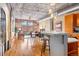 Open-concept living space combining kitchen, dining, and living areas, featuring hardwood floors and exposed piping at 1801 Wynkoop St # 411, Denver, CO 80202
