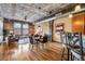 Open-concept living space combining kitchen, dining, and living areas, featuring hardwood floors and exposed piping at 1801 Wynkoop St # 411, Denver, CO 80202