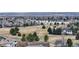 Scenic aerial view showcasing a golf course and lake surrounded by homes at 360 Peregrine Cir, Broomfield, CO 80020