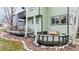 Inviting back deck perfect for entertaining, includes rock details, outdoor furniture, and a tranquil view at 360 Peregrine Cir, Broomfield, CO 80020