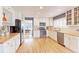 Well-lit kitchen boasts white cabinets, stainless appliances, and wood countertops at 360 Peregrine Cir, Broomfield, CO 80020