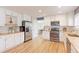Spacious kitchen with stainless appliances, white cabinetry, and wood countertops at 360 Peregrine Cir, Broomfield, CO 80020
