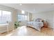 This main bedroom boasts natural light from skylights, a large window, and an attached sitting area at 360 Peregrine Cir, Broomfield, CO 80020