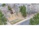 Aerial shot of a fun community playground with swings, slide and climbing area, set amidst trees at 360 Peregrine Cir, Broomfield, CO 80020