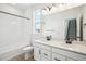 Bright bathroom with double vanity, a tub-shower, and modern fixtures at 8213 Butte Creek St, Littleton, CO 80125