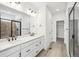 Modern bathroom features dual sinks, sleek black hardware, and a walk-in shower at 8213 Butte Creek St, Littleton, CO 80125
