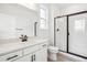 Modern bathroom with quartz counters, black accents, and a glass enclosed shower at 8213 Butte Creek St, Littleton, CO 80125