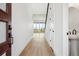 Bright entryway with light wood floors leading to an open living area, offering a view outside at 8213 Butte Creek St, Littleton, CO 80125