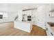 Kitchen showcasing an island with seating, modern fixtures, and an open-concept layout at 8213 Butte Creek St, Littleton, CO 80125