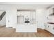Open kitchen featuring an island with bar seating, modern appliances, and seamless flow to living area at 8213 Butte Creek St, Littleton, CO 80125