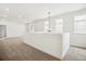 Bright living area features an open space with modern lighting and neutral carpeting at 8213 Butte Creek St, Littleton, CO 80125