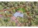 Aerial view of property with beautiful, mature tree coverage on a private lot, outlined in red at 900 Ballantine Rd, Golden, CO 80401
