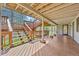 Covered back porch and steps with wooden features at 900 Ballantine Rd, Golden, CO 80401