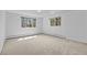 Bright bedroom with carpet flooring and two windows with natural light at 900 Ballantine Rd, Golden, CO 80401