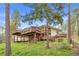 Exterior view of a multilevel home with wooden decks and a sloped yard at 900 Ballantine Rd, Golden, CO 80401