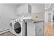 Clean laundry room with counter space and modern appliances at 900 Ballantine Rd, Golden, CO 80401