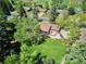 Aerial view of a manicured lawn, back patio, and mature trees surrounding the property at 3666 S Jersey St, Denver, CO 80237