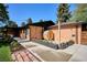Features a wood barrel sauna, custom planter boxes, a brick patio, and manicured landscaping at 3666 S Jersey St, Denver, CO 80237
