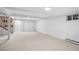 Large finished basement with neutral carpet, white walls and stairs at 3666 S Jersey St, Denver, CO 80237