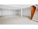Spacious, unfinished basement with white painted support beams and stairs at 3666 S Jersey St, Denver, CO 80237