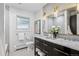 Stylish bathroom with double vanity, modern fixtures, and an elegant mirror at 3666 S Jersey St, Denver, CO 80237