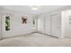 Simple bedroom with two windows, closet and neutral carpet at 3666 S Jersey St, Denver, CO 80237
