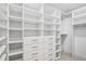 Spacious walk-in closet features built-in shelving and drawers for ample storage at 3666 S Jersey St, Denver, CO 80237