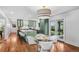 Sun-filled dining area adjacent to the kitchen, featuring stylish lighting, hardwood floors, and access to patio at 3666 S Jersey St, Denver, CO 80237