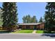 Charming single-story home with mature trees, manicured lawn, and brick exterior, offering great curb appeal at 3666 S Jersey St, Denver, CO 80237
