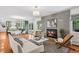 Inviting living room with a cozy fireplace, hardwood floors, and bright natural light at 3666 S Jersey St, Denver, CO 80237